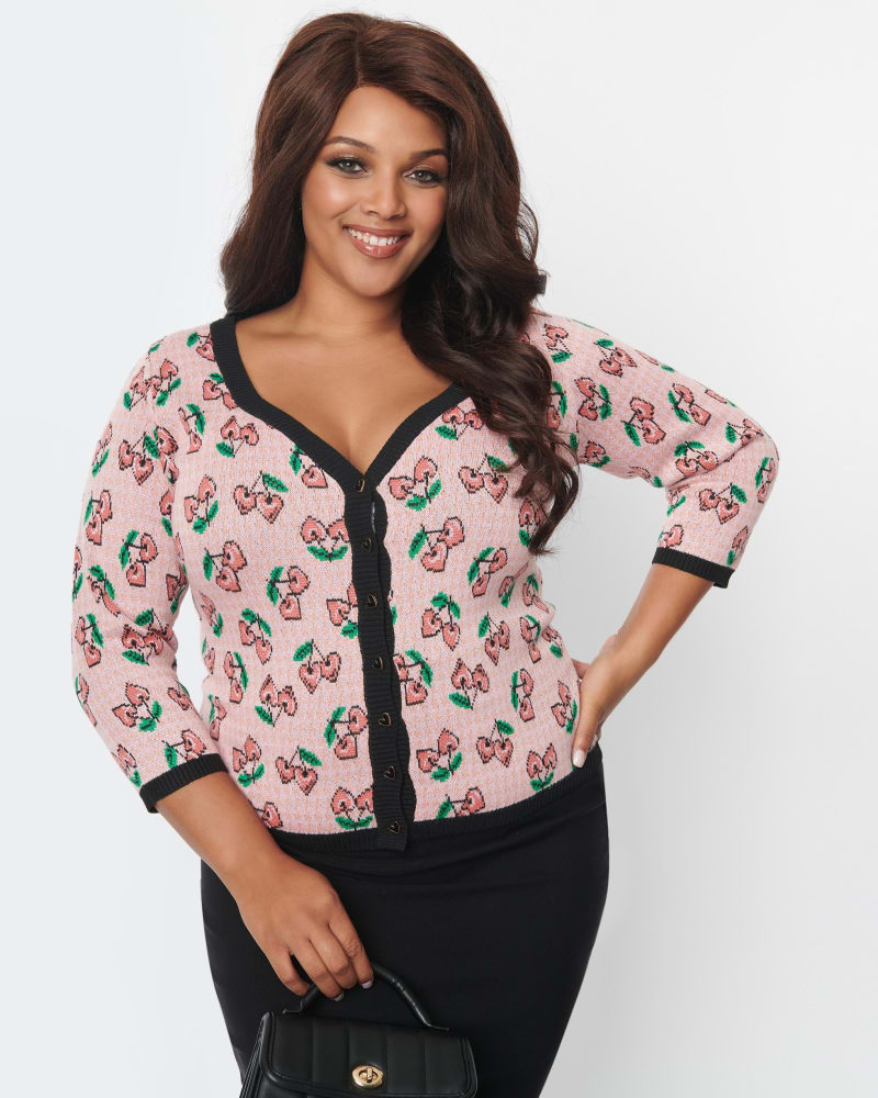 Front of a model wearing a size 1X/16 Unique Vintage Plus Size Pink & Cherry Hearts Cardigan in Pink & Cherry Hearts by Unique Vintage. | dia_product_style_image_id:269904